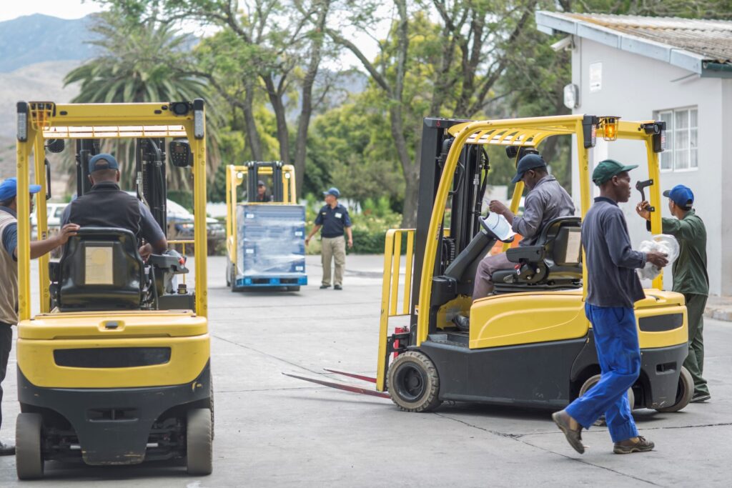 Busy forklift drivers at packaging factory